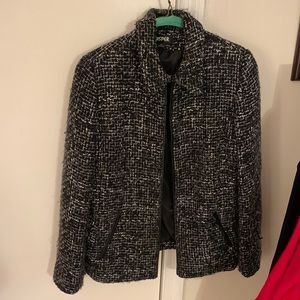 Black and white tweed jacket with leather trim and zipper closure
